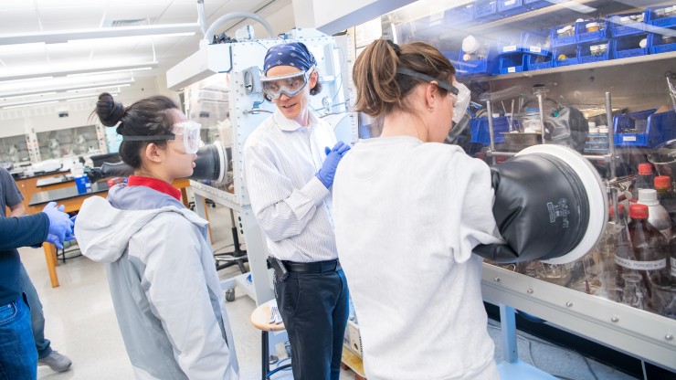 Professor Joseph Keane teaches students in the chemistry lab.